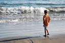  Jerome was happy at the edge of the waves.