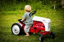  Ian toddled out to Seth’s tractor in the yard and got on it backwards. :-)